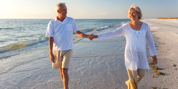 Senioren-Paar geht am Strand spazieren