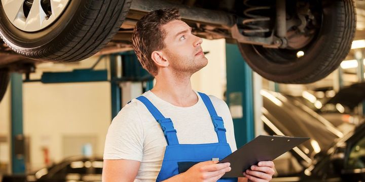 Mechaniker checkt Auto in der Werkstatt