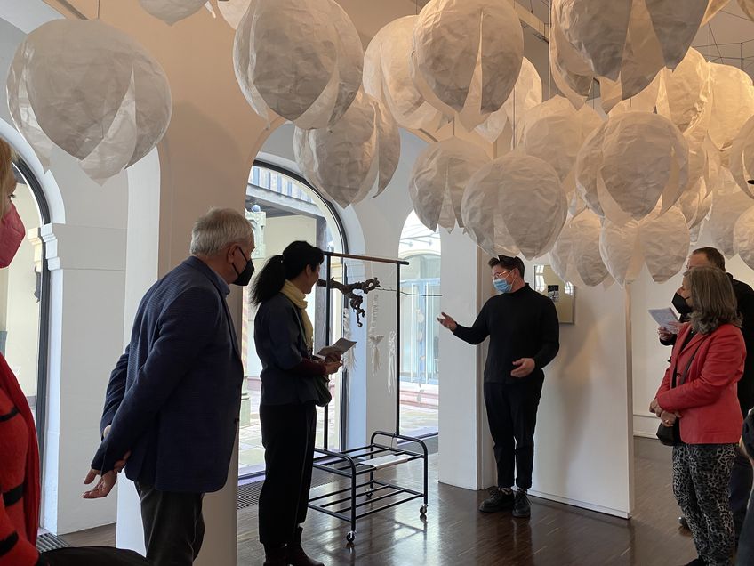 Die Künstlerin Peco Kawashima und der Leiter der Städtischen Galerie Fruchthalle, Sebastian Schmitt, führen durch die Ausstellung „Grafik! Grafik!“.