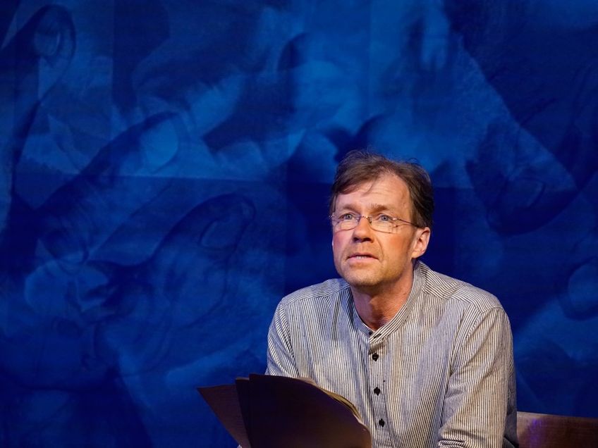 Norbert Ellts vor einem blauen Hintergrund