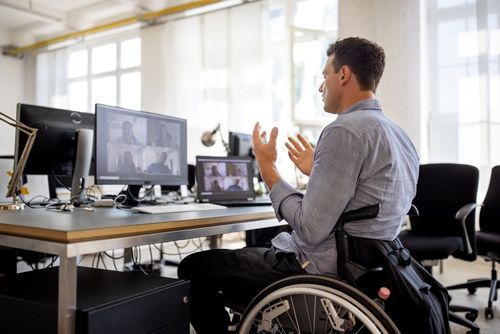 Ein Mitarbeiter im Rollstuhl im barrierefreien Büro